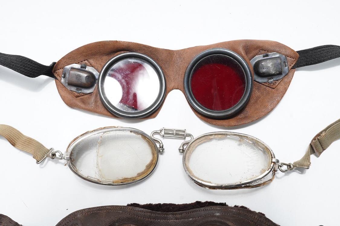 A pair of early aviation aluminium framed flying goggles, a pair of leather and felt lined goggles with green tinted lenses, a pair of French ? aviator flying goggles and a pair of WW2 First Pattern RAF Night Simulation